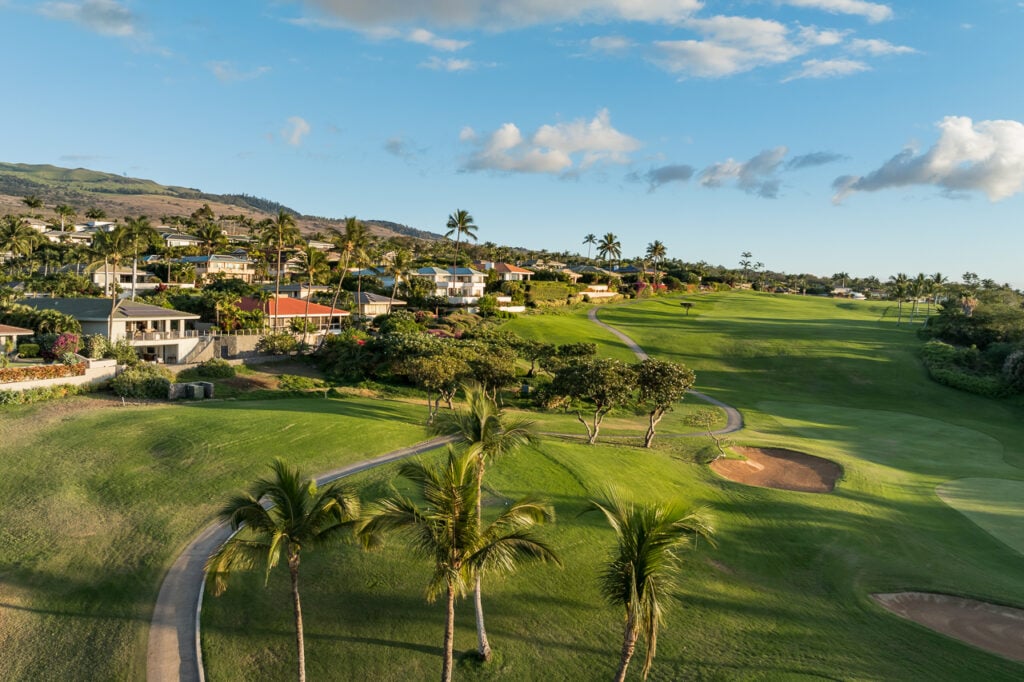 Luxury Maui Real Estate Agency. Image displays Luxury Maui homes located just off a green golf course